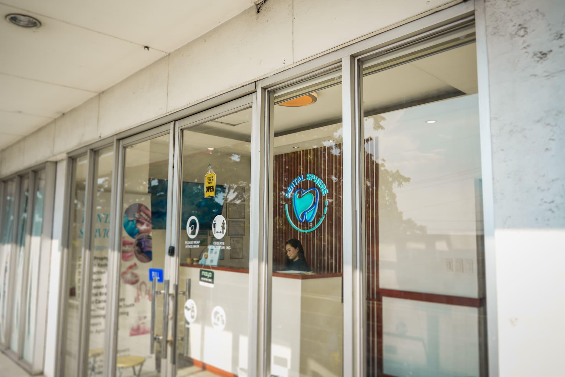 Glass entrance of the Dental Sphere clinic on the second floor