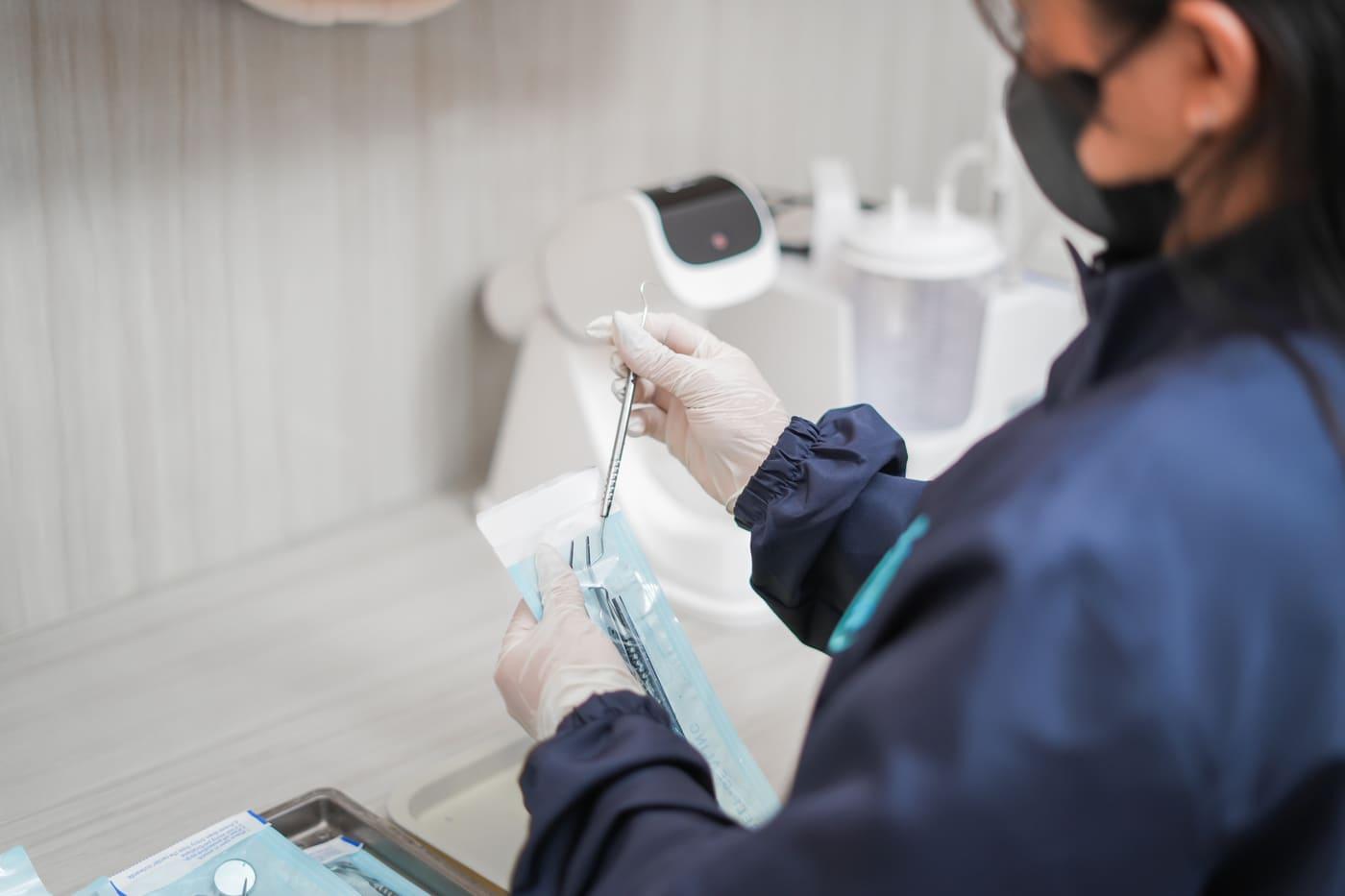 Staff preparing sealed sterilized instruments